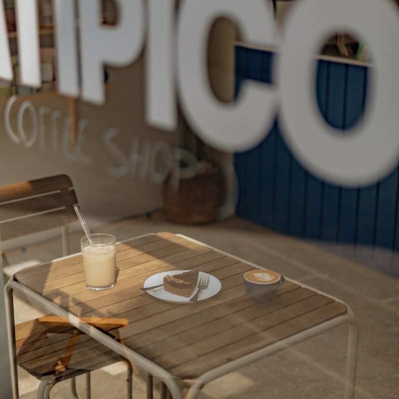 A table with a cup of coffee on top of it